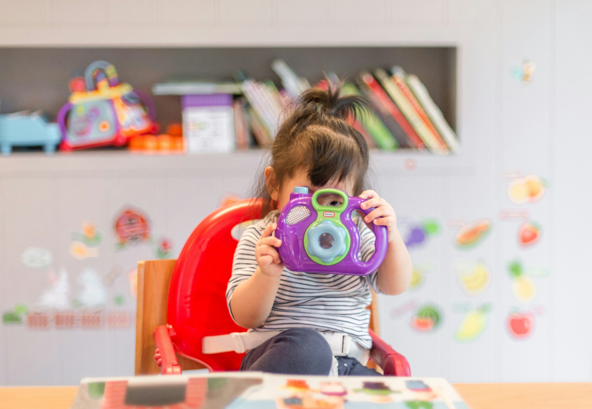 Child smiling in soft natural light—illustrative, not a patient