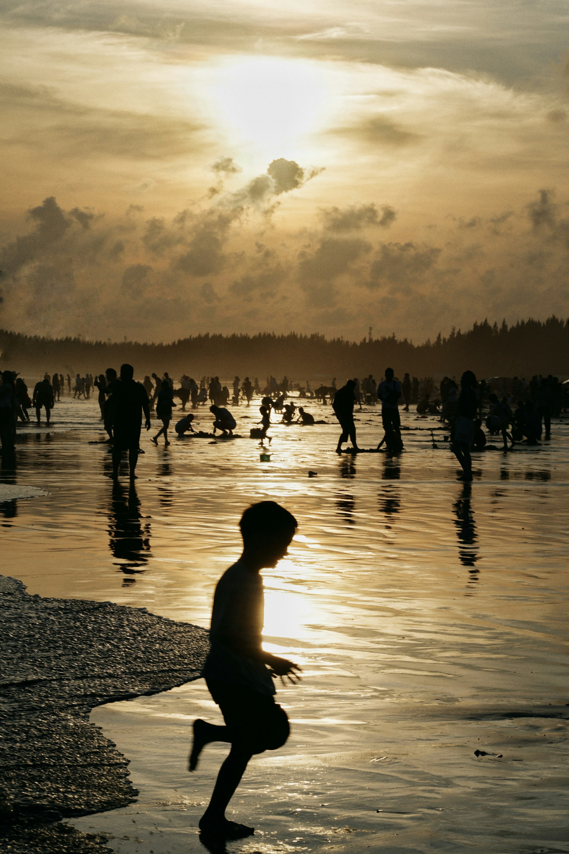 Child running on a beach at sunset—space, motion, and light