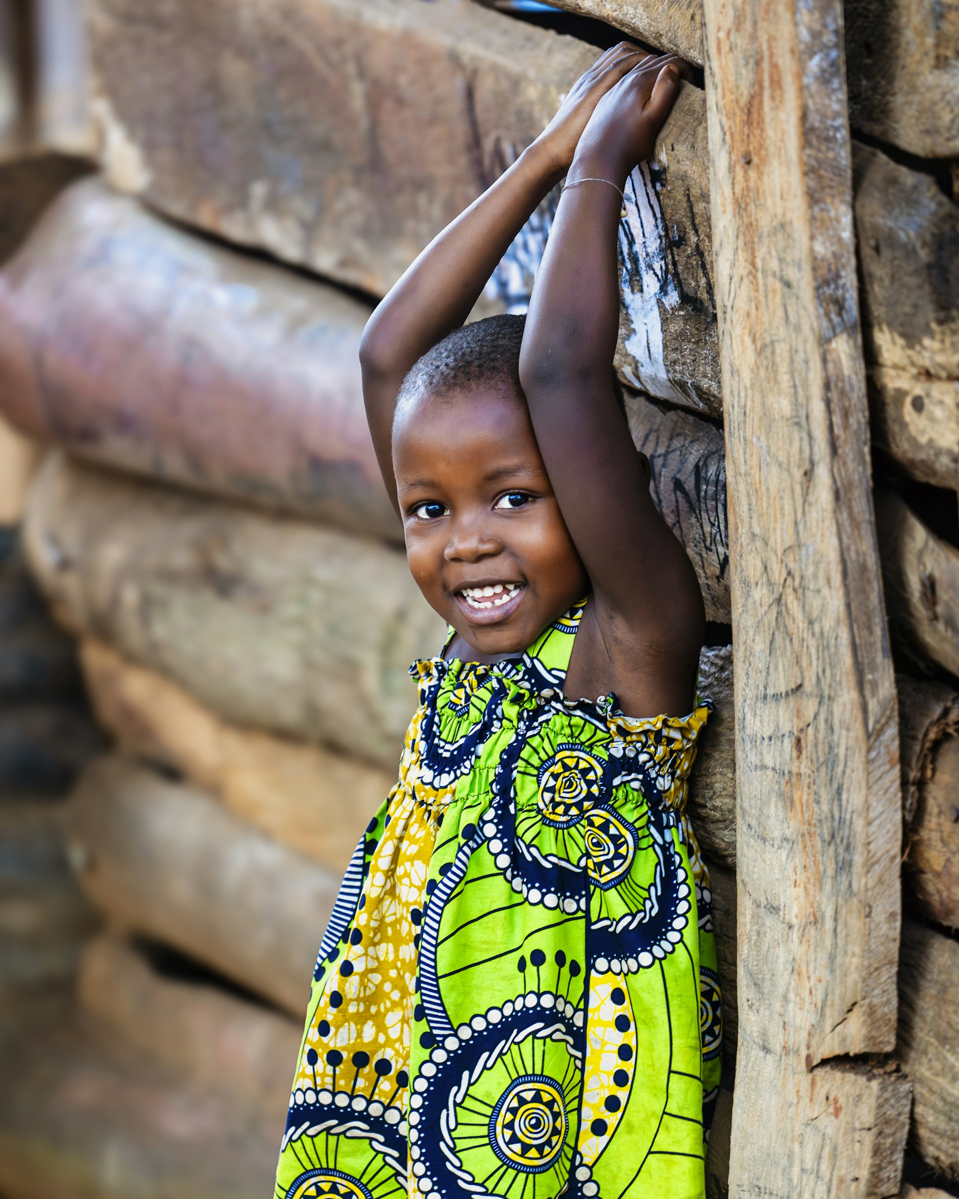 Young child smiling outdoors—warm, family-centered tone